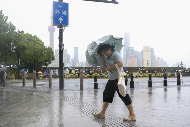 (260809) -- SHANGHAI, Aug. 9, 2026 (Xinhua) -- A woman with an umbrella walks amid rain at Huangpu District of Shanghai, east China, on Aug. 9, 2026. China's eastern metropolis Shanghai issued its highest rainstorm alert Sunday over rising risks of urban waterlogging brought by Typhoon Dolphin, the 13th typhoon of the year that has a great impact on the country's coastal regions.
   China's national observatory on Sunday activated a red alert -- the highest level in the country's typhoon warning system -- as Typhoon Dolphin approaches.
   Typhoon Dolphin is forecast to make landfall along the country's east coast from Sanmen in Zhejiang Province to Fuding in Fujian Province around Sunday evening to the early hours of Monday, according to the National Meteorological Center (NMC). (Xinhua/Wang Xiang)
