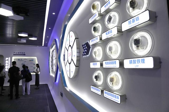 (260809) -- NINGXIANG, Aug. 9, 2026 (Xinhua) -- People visit the exhibition hall of the Hunan CNGR New Energy Technology Co., Ltd. in Ningxiang City, central China's Hunan Province, July 5, 2026. Ningxiang City has focused on developing the advanced energy storage materials industry and has built a complete industrial chain covering energy storage materials, battery cell manufacturing and used battery recycling. From January to May this year, the city had 43 major enterprises in the energy storage materials sector, with the industry's output value exceeding 26 billion yuan (about 3.6 billion U.S. dollars). (Xinhua/Lu Peng)