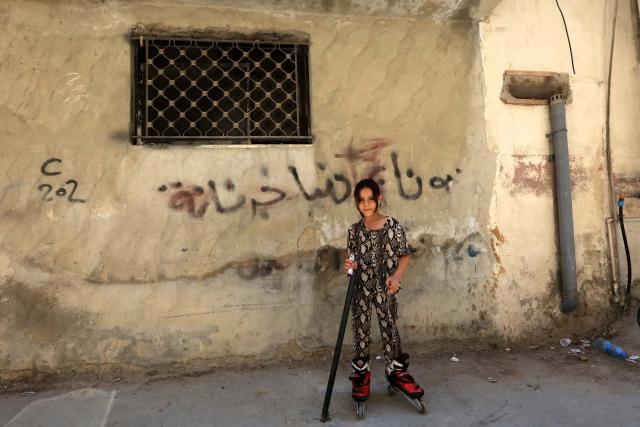 (260809) -- AMMAN, Aug. 9, 2026 (Xinhua) -- A girl plays on a street of Baqa'a refugee camp, Jordan, Aug. 9, 2026. (Photo by Mohammad Abu Ghosh/Xinhua)