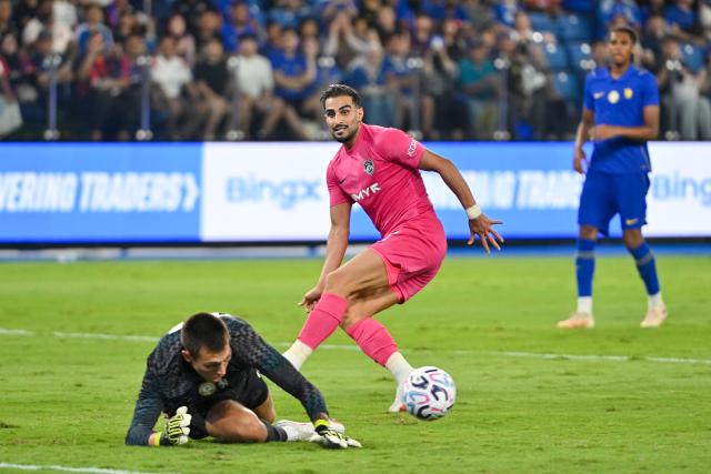 (260810) -- JOHOR BAHRU, Aug. 10, 2026 (Xinhua) -- Shahab Zaheditabar (C) of Johor Darul Ta'zim eyes on the ball which Gaga Slonina (L), goal keeper of Chelsea goes to save during a pre-season friendly football match between Johor Darul Ta'zim from Malaysia Super League and Chelsea FC from Premier League at Sultan Ibrahim Stadium in Johor Bahru, Malaysia, Aug. 9, 2026. (Photo by Chong Voon Chung/Xinhua)