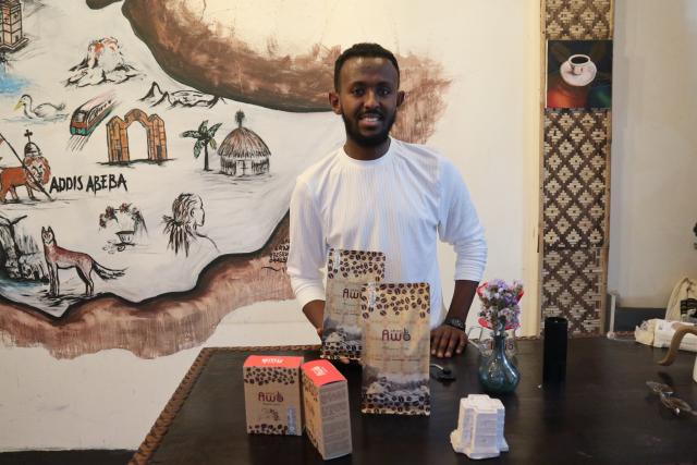 (260810) -- NAIROBI, Aug. 10, 2026 (Xinhua) -- A staff member presents coffee products of Awo Coffee in Addis Ababa, Ethiopia, Oct. 26, 2025. (Xinhua/Liu Fangqiang)