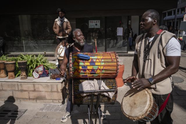 (260810) -- JOHANNESBURG, Aug. 10, 2026 (Xinhua) -- People enjoy music on a street during a car-free event in Johannesburg, South Africa, Aug. 9, 2026. During the event, some streets in Johannesburg were turned into car-free zones from 10 a.m. to 5 p.m., with motor vehicles banned. (Photo by Ihsaan Haffejee/Xinhua)