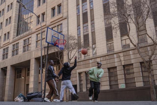 (260810) -- JOHANNESBURG, Aug. 10, 2026 (Xinhua) -- People play basketball on a street during a car-free event in Johannesburg, South Africa, Aug. 9, 2026. During the event, some streets in Johannesburg were turned into car-free zones from 10 a.m. to 5 p.m., with motor vehicles banned. (Photo by Ihsaan Haffejee/Xinhua)