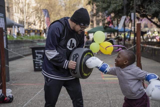 (260810) -- JOHANNESBURG, Aug. 10, 2026 (Xinhua) -- People enjoy boxing on a street during a car-free event in Johannesburg, South Africa, Aug. 9, 2026. During the event, some streets in Johannesburg were turned into car-free zones from 10 a.m. to 5 p.m., with motor vehicles banned. (Photo by Ihsaan Haffejee/Xinhua)