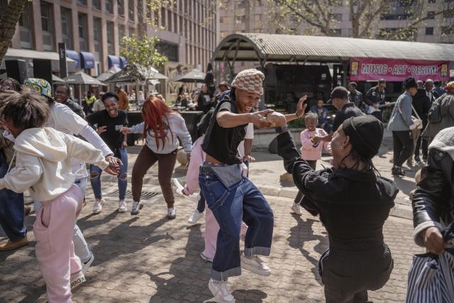 (260810) -- JOHANNESBURG, Aug. 10, 2026 (Xinhua) -- People dance on a street during a car-free event in Johannesburg, South Africa, Aug. 9, 2026. During the event, some streets in Johannesburg were turned into car-free zones from 10 a.m. to 5 p.m., with motor vehicles banned. (Photo by Ihsaan Haffejee/Xinhua)