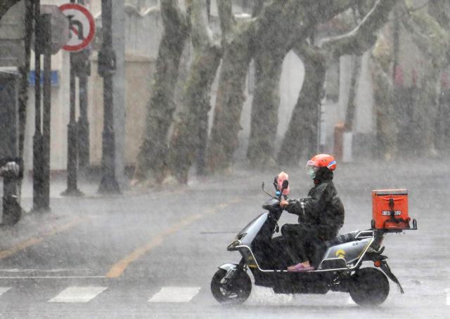 (260810) -- BEIJING, Aug. 10, 2026 (Xinhua) -- A delivery rider rides a motorcycle in the rain in Suzhou, east China's Jiangsu Province, Aug. 10, 2026. Typhoon Dolphin is moving inland after making two landfalls along the coast of east China's Zhejiang Province and is expected to bring heavy precipitation to more than 10 provincial-level regions, according to China's National Meteorological Center on Monday.
   The center issued a blue typhoon warning on Monday morning, forecasting persistent heavy rainfall through Wednesday in regions including Zhejiang, Jiangsu, Henan and Hebei. Some areas are likely to experience torrential rain, thunderstorms and strong winds.
   Authorities in multiple localities have made all-out efforts in flood prevention and typhoon response. (Photo by Hang Xingwei/Xinhua)