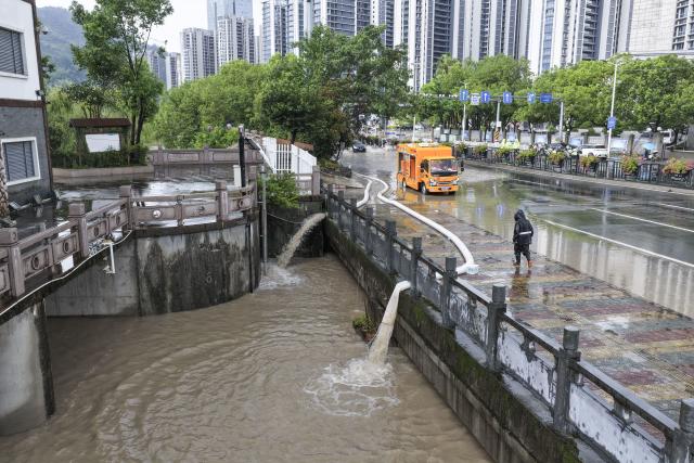 (260810) -- WENZHOU, Aug. 10, 2026 (Xinhua) -- A drone photo taken on Aug. 10, 2026 shows high-power pumps draining floodwaters from a street in Shangtang Town in Wenzhou, east China's Zhejiang Province. Typhoon Dolphin is moving inland after making two landfalls along the coast of east China's Zhejiang Province and is expected to bring heavy precipitation to more than 10 provincial-level regions, according to China's National Meteorological Center on Monday. (Photo by Su Qiaojiang/Xinhua)