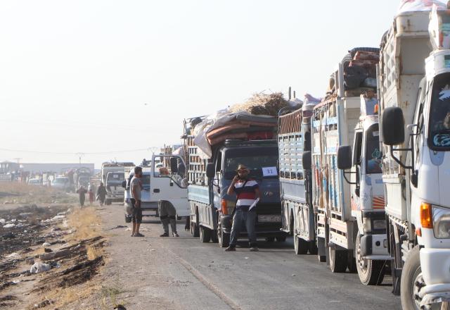 (260810) -- HASAKAH, Aug. 10, 2026 (Xinhua) -- Trucks loaded with the belongings of displaced Syrian families line up as a convoy prepares to head toward the city of Ras al-Ain and its surrounding villages in Hasakah province, northeastern Syria, Aug. 10, 2026. More than 400 Syrian families returned to the city of Ras al-Ain in northeastern Hasakah province and its surrounding villages on Monday, marking the first organized convoy of displaced residents heading home in that area after nearly seven years of displacement. (Str/Xinhua)
