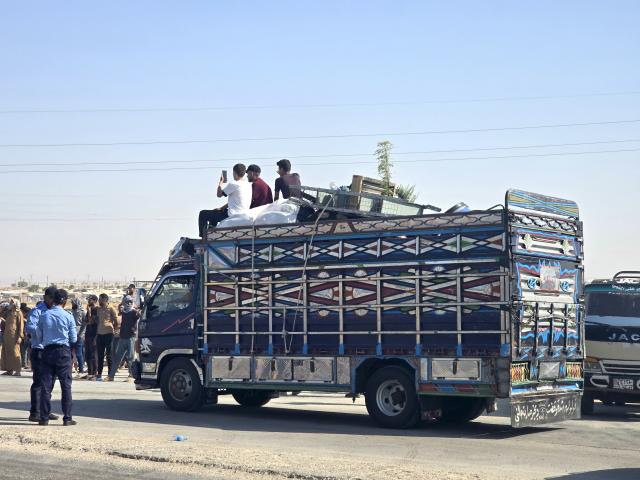 (260810) -- HASAKAH, Aug. 10, 2026 (Xinhua) -- Displaced Syrians travel with their belongings aboard a truck as a convoy heads toward the city of Ras al-Ain and its surrounding villages in Hasakah province, northeastern Syria, Aug. 10, 2026. More than 400 Syrian families returned to the city of Ras al-Ain in northeastern Hasakah province and its surrounding villages on Monday, marking the first organized convoy of displaced residents heading home in that area after nearly seven years of displacement. (Str/Xinhua)
