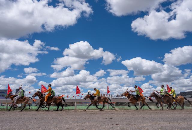 (260811) -- BEIJING, Aug. 11, 2026 (Xinhua) -- Horse racers compete during the invitational 12,000m walking race of famous horse at the Nagqu Horse Racing Festival 2026 at Gesar Racecourse in Nagqu, southwest China's Xizang Autonomous Region, Aug. 10, 2026. Featuring traditional equestrian contests, ethnic sports performances and trade fair, the event kicked off here on Monday, drawing large crowds of locals and visitors. (Xinhua/Sun Fei)