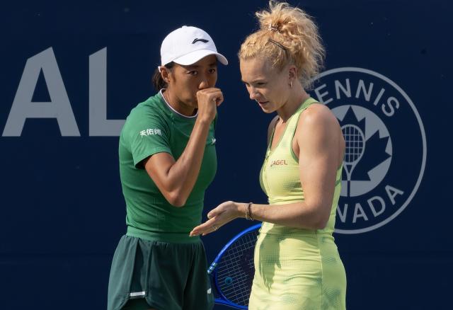 (260811) -- TORONTO, Aug. 11, 2026 (Xinhua) -- Katerina Siniakova/Zhang Shuai (L) talk to each other during the women's doubles quarterfinal match between Katerina Siniakova (the Czech Republic)/Zhang Shuai (China) and Storm Hunter (Australia)/Desirae Krawczyk (the United States) at the 2026 National Bank Open tennis tournament in Toronto, Canada, Aug. 10, 2026. (Photo by Zou Zheng/Xinhua)