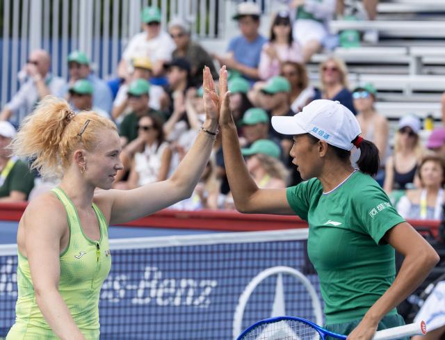 (260811) -- TORONTO, Aug. 11, 2026 (Xinhua) -- Katerina Siniakova/Zhang Shuai (R) celebrate scoring during the women's doubles quarterfinal match between Katerina Siniakova (the Czech Republic)/Zhang Shuai (China) and Storm Hunter (Australia)/Desirae Krawczyk (the United States) at the 2026 National Bank Open tennis tournament in Toronto, Canada, Aug. 10, 2026. (Photo by Zou Zheng/Xinhua)