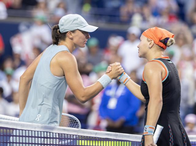 (260811) -- TORONTO, Aug. 11, 2026 (Xinhua) -- Iga Swiatek (L) of Poland and Diana Shnaider of Russia shake hands after their women's singles quarterfinal match at the 2026 National Bank Open tennis tournament in Toronto, Canada, on Aug. 10, 2026. (Photo by Zou Zheng/Xinhua)