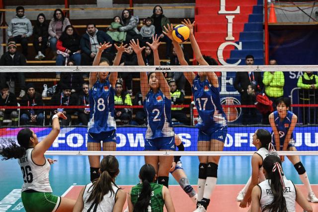 (260811) -- SAN FELIPE, Aug. 11, 2026 (Xinhua) -- Zhang Yijia, Xu Ruilin and Niu Sidi (Top, L to R) of China block the ball during the Pool B Preliminary Phase match between China and Mexico at the FIVB Volleyball Girls' U17 World Championship in San Felipe, Chile, Aug. 10, 2026. (Photo by Jorge Villegas/Xinhua)