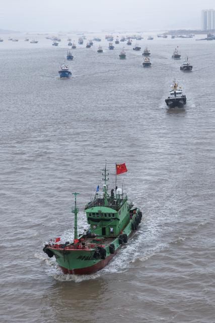 (260811) -- ZHOUSHAN, Aug. 11, 2026 (Xinhua) -- Fishing boats set sail for fishing from Shenjiamen Port in Zhoushan, east China's Zhejiang Province, Aug. 11, 2026. Four types of fishing boats with special permission set sail on Tuesday after a three-month summer fishing ban in the East China Sea. The opening of the fishing season was delayed from the originally scheduled Aug. 5 due to Typhoon Dolphin. (Xinhua/Xu Yu)
