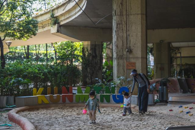 (260811) -- KUNMING, Aug. 11, 2026 (Xinhua) -- Children play at a playground beneath a flyover in Kunming, southwest China's Yunnan Province, Aug. 11, 2026. In recent years, Kunming has transformed some vacant areas beneath urban bridges and flyovers into public spaces for greenery, leisure, recreation and physical exercises, making the city more livable for residents. (Xinhua/Wang Guansen)