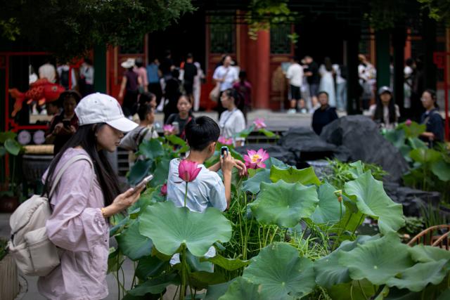 (260811) -- BEIJING, Aug. 11, 2026 (Xinhua) -- People visit a goldfish exhibition at the Prince Kung's Palace Museum in Beijing, capital of China, Aug. 11, 2026. The museum opened its fifth goldfish exhibition on Tuesday. (Xinhua)