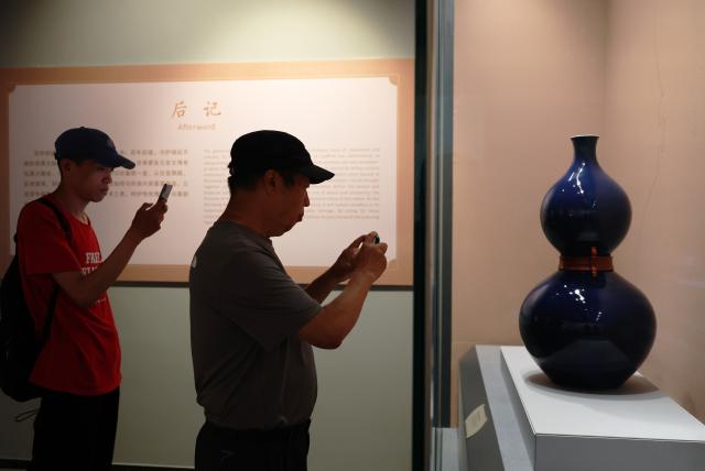 (260811) -- SHENYANG, Aug. 11, 2026 (Xinhua) -- People visit the exhibition titled "A Nation in Treasures: Selected Masterpieces Marking the Centenary of the Shenyang Imperial Palace Museum" at Shenyang Palace Museum in Shenyang, northeast China's Liaoning Province, Aug. 11, 2026. The exhibition revisits the museum's 100-year history through 100 exhibits in multiple categories, and is expected to run until the end of the year. (Xinhua/Li Gang)