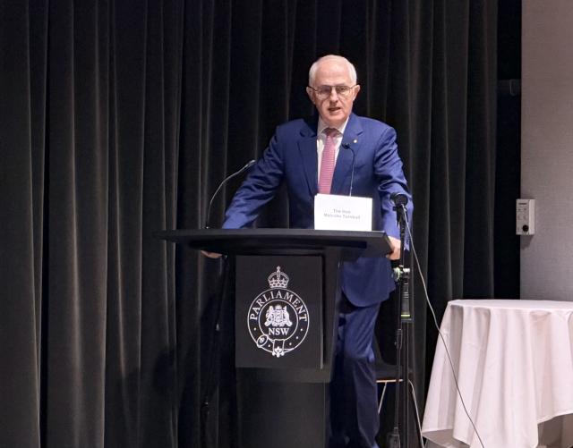 (260811) -- SYDNEY, Aug. 11, 2026 (Xinhua) -- This photo taken with a mobile phone shows former Australian Prime Minister Malcolm Turnbull speaking at a hearing of the AUKUS Public Inquiry at NSW Parliament House in Sydney, Australia, Aug. 10, 2026. TO GO WITH "Former Australian PM says AUKUS to make Australia less safe" (Xinhua/Liu Xiaoyu)
