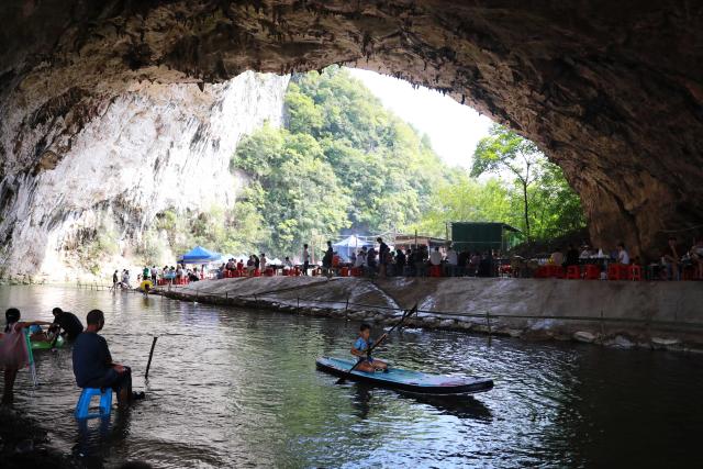 (260811) -- GUIYANG, Aug. 11, 2026 (Xinhua) -- Tourists have fun inside a karst cave in Kaili City, Qiandongnan Miao and Dong Autonomous Prefecture, southwest China's Guizhou Province, Aug. 8, 2026. Best known for its karst landscape, Guizhou has made the best of karst caves to develop distinctive sites for cooling retreats. Featuring natural geological wonders, cooling enjoyment and water amusements, this emerging tourist experience has become a hit among locals and visitors alike. (Photo by Wu Xianyan/Xinhua)