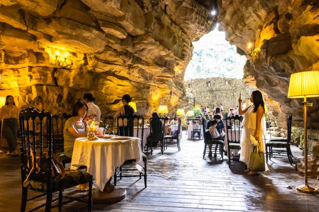 (260811) -- GUIYANG, Aug. 11, 2026 (Xinhua) -- Tourists enjoy themselves at a cafe inside a karst cave in Anshun City, southwest China's Guizhou Province, Aug. 8, 2026. Best known for its karst landscape, Guizhou has made the best of karst caves to develop distinctive sites for cooling retreats. Featuring natural geological wonders, cooling enjoyment and water amusements, this emerging tourist experience has become a hit among locals and visitors alike. (Photo by Chen Xi/Xinhua)