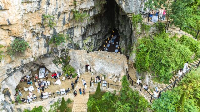 (260811) -- GUIYANG, Aug. 11, 2026 (Xinhua) -- A drone photo taken on Aug. 8, 2026 shows tourists visiting a cafe inside a karst cave in Anshun City, southwest China's Guizhou Province. Best known for its karst landscape, Guizhou has made the best of karst caves to develop distinctive sites for cooling retreats. Featuring natural geological wonders, cooling enjoyment and water amusements, this emerging tourist experience has become a hit among locals and visitors alike. (Photo by Chen Xi/Xinhua)