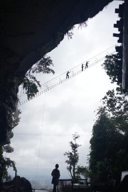 (260811) -- GUIYANG, Aug. 11, 2026 (Xinhua) -- Tourists enjoy via ferrata climb at a karst cave in Zunyi City, southwest China's Guizhou Province, Aug. 7, 2026. Best known for its karst landscape, Guizhou has made the best of karst caves to develop distinctive sites for cooling retreats. Featuring natural geological wonders, cooling enjoyment and water amusements, this emerging tourist experience has become a hit among locals and visitors alike. (Photo by Zhang Zhengju/Xinhua)
