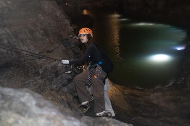 (260811) -- GUIYANG, Aug. 11, 2026 (Xinhua) -- A tourist enjoys via ferrata climb inside a karst cave in Suiyang County, southwest China's Guizhou Province, Aug. 6, 2026. Best known for its karst landscape, Guizhou has made the best of karst caves to develop distinctive sites for cooling retreats. Featuring natural geological wonders, cooling enjoyment and water amusements, this emerging tourist experience has become a hit among locals and visitors alike. (Photo by Li Qianyong/Xinhua)
