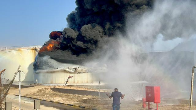 (260811) -- TRIPOLI, Aug. 11, 2026 (Xinhua) -- This photo taken with a mobile phone shows a fuel tank still burning at the Zawiya oil refinery in Zawiya, western Libya, Aug. 11, 2026. Libya's National Oil Corporation (NOC) on Monday night said in a statement that a fuel tank at the Zawiya oil refinery was directly targeted, causing a severe fire and the complete collapse of the tank. (Str/Xinhua)