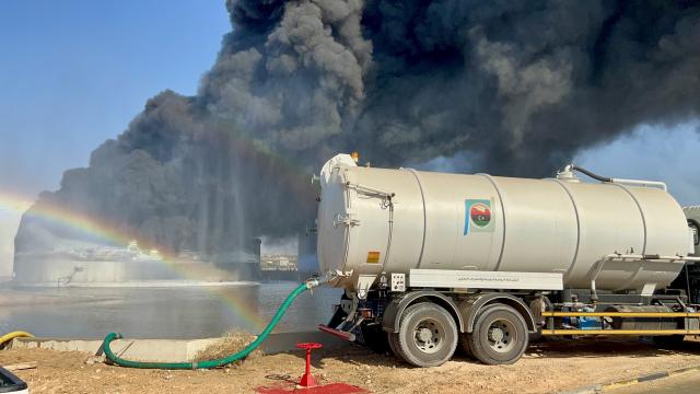 (260811) -- TRIPOLI, Aug. 11, 2026 (Xinhua) -- This photo taken with a mobile phone shows a fuel tank still burning at the Zawiya oil refinery in Zawiya, western Libya, Aug. 11, 2026. Libya's National Oil Corporation (NOC) on Monday night said in a statement that a fuel tank at the Zawiya oil refinery was directly targeted, causing a severe fire and the complete collapse of the tank. (Str/Xinhua)