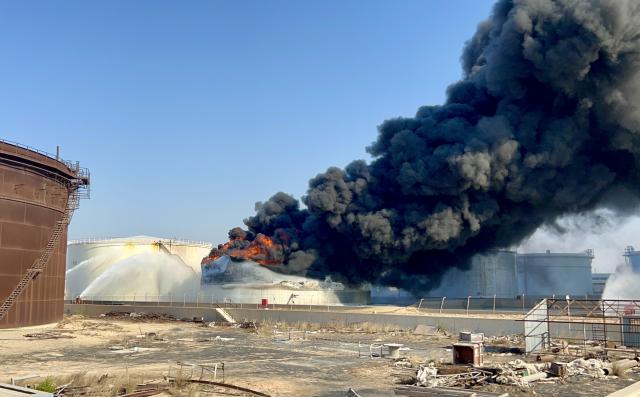 (260811) -- TRIPOLI, Aug. 11, 2026 (Xinhua) -- This photo taken with a mobile phone shows a fuel tank still burning at the Zawiya oil refinery in Zawiya, western Libya, Aug. 11, 2026. Libya's National Oil Corporation (NOC) on Monday night said in a statement that a fuel tank at the Zawiya oil refinery was directly targeted, causing a severe fire and the complete collapse of the tank. (Str/Xinhua)