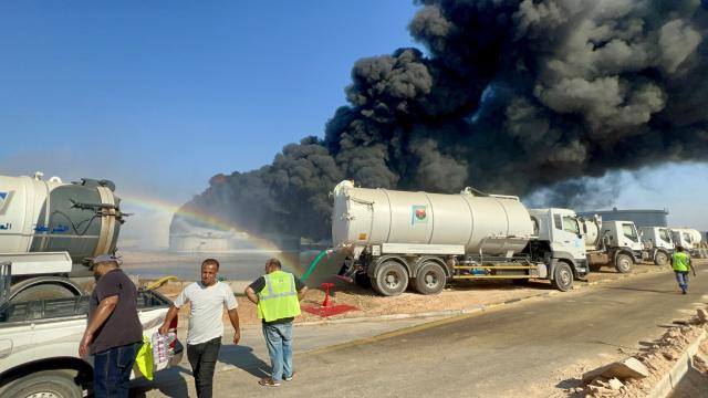(260811) -- TRIPOLI, Aug. 11, 2026 (Xinhua) -- This photo taken with a mobile phone shows a fuel tank still burning at the Zawiya oil refinery in Zawiya, western Libya, Aug. 11, 2026. Libya's National Oil Corporation (NOC) on Monday night said in a statement that a fuel tank at the Zawiya oil refinery was directly targeted, causing a severe fire and the complete collapse of the tank. (Str/Xinhua)
