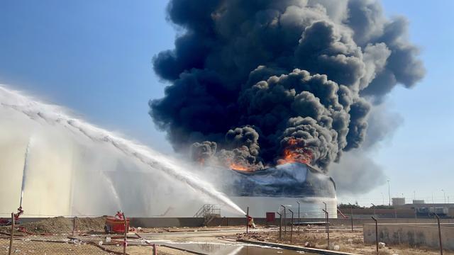 (260811) -- TRIPOLI, Aug. 11, 2026 (Xinhua) -- This photo taken with a mobile phone shows a fuel tank still burning at the Zawiya oil refinery in Zawiya, western Libya, Aug. 11, 2026. Libya's National Oil Corporation (NOC) on Monday night said in a statement that a fuel tank at the Zawiya oil refinery was directly targeted, causing a severe fire and the complete collapse of the tank. (Str/Xinhua)