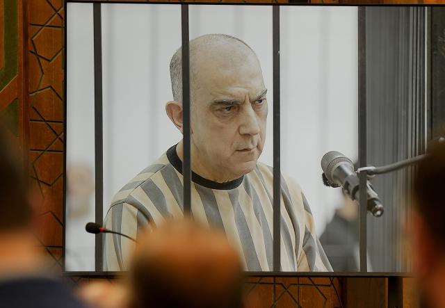 (260812) -- DAMASCUS , Aug. 12, 2026 (Xinhua) -- Syrian former senior security official Atef Najib is seen on a courtroom screen during a court session in Damascus, Syria, Aug. 11, 2026.
  The Fourth Criminal Court in Damascus on Tuesday sentenced Najib to death over killings and abuses linked to the Syrian conflict, according to reports on the court proceedings. (Photo by Ammar Safarjalani/Xinhua)
