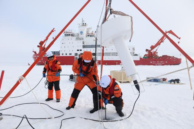 (260812) -- XUELONG 2, Aug. 12, 2026 (Xinhua) -- Members of China's 16th Arctic Ocean scientific expedition team work on the ice surface of the Arctic Ocean on Aug. 9, 2026. China's research icebreaker Xuelong 2 will carry out more than 20 operations at seven ice stations, including deploying ice-based buoys, collecting ice cores and conducting remote sensing observations of sea ice, to obtain scientific data for research into changes in Arctic sea ice and the evolution of its ecosystems. (Xinhua/Wen Jinghua)