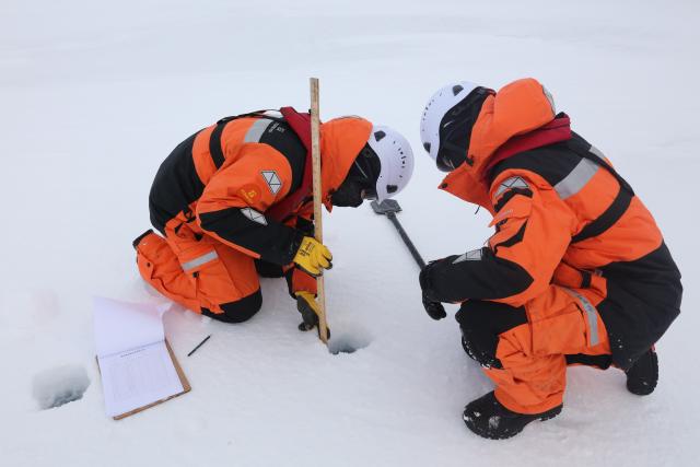 (260812) -- XUELONG 2, Aug. 12, 2026 (Xinhua) -- Members of China's 16th Arctic Ocean scientific expedition team work on the ice surface of the Arctic Ocean on Aug. 9, 2026. China's research icebreaker Xuelong 2 will carry out more than 20 operations at seven ice stations, including deploying ice-based buoys, collecting ice cores and conducting remote sensing observations of sea ice, to obtain scientific data for research into changes in Arctic sea ice and the evolution of its ecosystems. (Xinhua/Wen Jinghua)