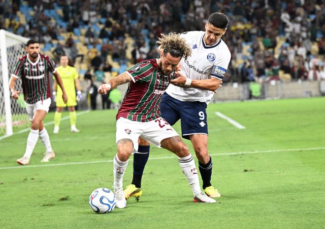 (260812) -- RIO DE JANEIRO, Aug. 12, 2026 (Xinhua) -- Guga (2nd R) of Fluminense and Alex Arce of Independiente Rivadavia vie for the ball during the first leg of the Copa Libertadores round of 16 football match between Brazil's Fluminense and Argentina's Independiente Rivadavia at the Maracana stadium in Rio de Janeiro, Brazil, on Aug. 11, 2026. (Xinhua/Jin Haoyuan)