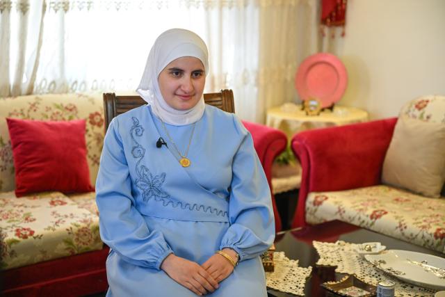 (260812) -- AMMAN, Aug. 12, 2026 (Xinhua) -- Manal Al-Khammash gets an interview with Xinhua at her home in Amman, Jordan, July 20, 2026. TO GO WITH "Feature: From Amman to Beijing: Young sinologist builds a literary bridge between Arab and Chinese cultures" (Xinhua/Xin Mengchen)