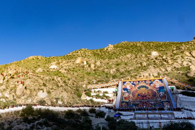 (260812) -- LHASA, Aug. 12, 2026 (Xinhua) -- People view an enormous thangka painting of Buddha at the Drepung Monastery in Lhasa, southwest China's Xizang Autonomous Region, Aug. 12. 2026.
  Celebrations marking the traditional Shoton Festival began in Lhasa on Wednesday. (Xinhua/Jiang Fan)