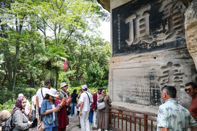 (260812) -- CHONGQING, Aug. 12, 2026 (Xinhua) -- International tourists visit the scenic area of Dazu Rock Carvings in Dazu District of southwest China's Chongqing Municipality, Aug. 11, 2026. In recent years, as China has continued to optimize its visa-free policies and other measures to facilitate travel, "China Travel" has gained global popularity, while "China Cool" has emerged as a buzzword during the summer. 
  Dazu Rock Carvings, a UNESCO World Heritage Site in Dazu District of southwest China's Chongqing Municipality, have become a popular destination for international tourists.
   According to data from the local cultural and tourism department, the site received 134,000 inbound tourist visits in 2025, up 90.07 percent year on year. From January to May this year, Dazu District recorded 68,000 inbound tourist arrivals, up 21 percent year on year. (Xinhua/Huang Wei)