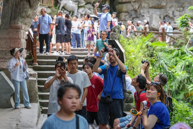 (260812) -- CHONGQING, Aug. 12, 2026 (Xinhua) -- International tourists visit the scenic area of Dazu Rock Carvings in Dazu District of southwest China's Chongqing Municipality, Aug. 11, 2026. In recent years, as China has continued to optimize its visa-free policies and other measures to facilitate travel, "China Travel" has gained global popularity, while "China Cool" has emerged as a buzzword during the summer. 
  Dazu Rock Carvings, a UNESCO World Heritage Site in Dazu District of southwest China's Chongqing Municipality, have become a popular destination for international tourists.
   According to data from the local cultural and tourism department, the site received 134,000 inbound tourist visits in 2025, up 90.07 percent year on year. From January to May this year, Dazu District recorded 68,000 inbound tourist arrivals, up 21 percent year on year. (Xinhua/Huang Wei)