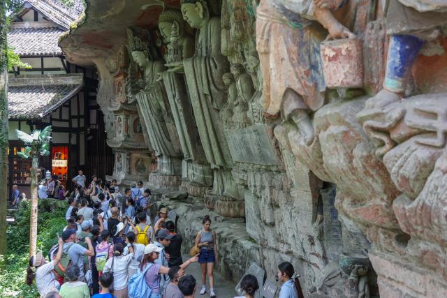 (260812) -- CHONGQING, Aug. 12, 2026 (Xinhua) -- Tourists visit the scenic area of Dazu Rock Carvings in Dazu District of southwest China's Chongqing Municipality, Aug. 11, 2026. In recent years, as China has continued to optimize its visa-free policies and other measures to facilitate travel, "China Travel" has gained global popularity, while "China Cool" has emerged as a buzzword during the summer. 
  Dazu Rock Carvings, a UNESCO World Heritage Site in Dazu District of southwest China's Chongqing Municipality, have become a popular destination for international tourists.
   According to data from the local cultural and tourism department, the site received 134,000 inbound tourist visits in 2025, up 90.07 percent year on year. From January to May this year, Dazu District recorded 68,000 inbound tourist arrivals, up 21 percent year on year. (Xinhua/Huang Wei)