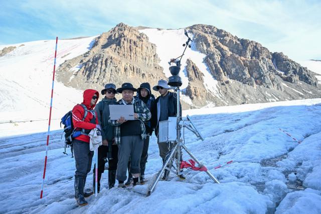 (260812) -- URUMQI, Aug. 12, 2026 (Xinhua) -- Researchers conduct scientific research on the Muz Taw Glacier in Altay, northwest China's Xinjiang Uygur Autonomous Region, Aug. 10, 2026. In recent days, a scientific expedition to the Muz Taw Glacier in Altay was carried out by a research team from the Altay Mountains comprehensive observation and research station, in an effort to better understand the glacier's response to climate change and provide scientific data for glacier protection and water resources management in the region. 
The team, affiliated with the Northwest Institute of Eco-Environment and Resources under the Chinese Academy of Sciences (CAS), conducted field observations at an altitude of 3,400 meters on the glacier, and systematically collected key data on meteorology, hydrology and glacier changes. (Xinhua/Ding Lei)