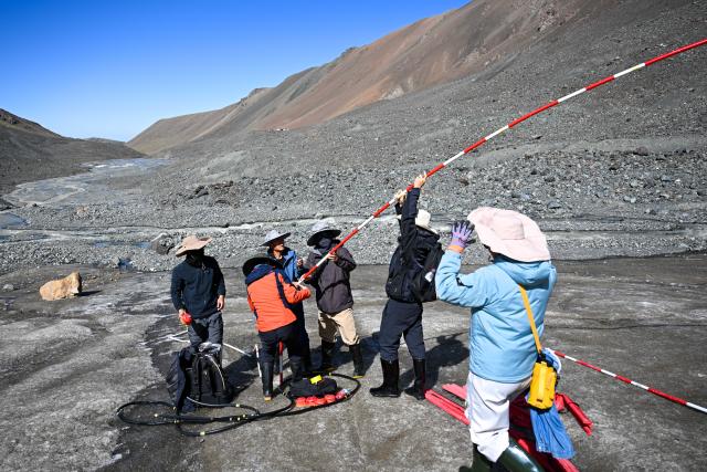 (260812) -- URUMQI, Aug. 12, 2026 (Xinhua) -- Researchers conduct scientific research on the Muz Taw Glacier in Altay, northwest China's Xinjiang Uygur Autonomous Region, Aug. 10, 2026. In recent days, a scientific expedition to the Muz Taw Glacier in Altay was carried out by a research team from the Altay Mountains comprehensive observation and research station, in an effort to better understand the glacier's response to climate change and provide scientific data for glacier protection and water resources management in the region. 
The team, affiliated with the Northwest Institute of Eco-Environment and Resources under the Chinese Academy of Sciences (CAS), conducted field observations at an altitude of 3,400 meters on the glacier, and systematically collected key data on meteorology, hydrology and glacier changes. (Xinhua/Ding Lei)