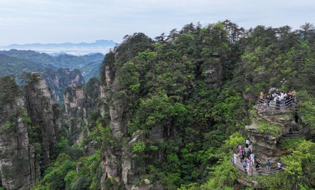 (260812) -- BEIJING, Aug. 12, 2026 (Xinhua) -- A drone photo taken on May 3, 2026 shows people visiting the Huangshizhai scenic spot in Zhangjiajie, central China's Hunan Province. (Photo by Wu Yongbing/Xinhua)