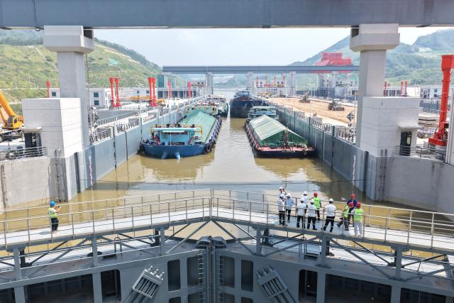 (260812) -- LINGSHAN, Aug. 12, 2026 (Xinhua) -- An aerial drone photo taken on Aug. 12, 2026 shows trial vessels driving into a navigation lock on the Pinglu Canal in south China's Guangxi Zhuang Autonomous Region. Pinglu Canal started vessel trials on Wednesday, marking a key step toward the planned opening of this major Chinese waterway in September.
   The tests will assess navigation under both normal and adverse conditions and examine whether the canal's waterways, locks, anchorages, service areas and navigation facilities are ready for operation.
   Designed to accommodate vessels of up to 5,000 tonnes, the 134.2-km Pinglu Canal is China's first major river-to-sea canal project planned and coordinated at the national level since 1949.
   Stretching from the Pingtang River in Guangxi's Hengzhou City to the Beibu Gulf in the South China Sea, the canal is the backbone of the country's New International Land-Sea Trade Corridor, which has evolved into a strategic route linking China's inland regions with ASEAN and other global markets. (Xinhua/Zhou Hua)