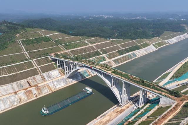 (260812) -- LINGSHAN, Aug. 12, 2026 (Xinhua) -- An aerial drone photo taken on Aug. 12, 2026 shows a trial vessel driving past a bridge for animals over the Pinglu Canal in south China's Guangxi Zhuang Autonomous Region. Pinglu Canal started vessel trials on Wednesday, marking a key step toward the planned opening of this major Chinese waterway in September.
   The tests will assess navigation under both normal and adverse conditions and examine whether the canal's waterways, locks, anchorages, service areas and navigation facilities are ready for operation.
   Designed to accommodate vessels of up to 5,000 tonnes, the 134.2-km Pinglu Canal is China's first major river-to-sea canal project planned and coordinated at the national level since 1949.
   Stretching from the Pingtang River in Guangxi's Hengzhou City to the Beibu Gulf in the South China Sea, the canal is the backbone of the country's New International Land-Sea Trade Corridor, which has evolved into a strategic route linking China's inland regions with ASEAN and other global markets. (Xinhua/Zhou Hua)