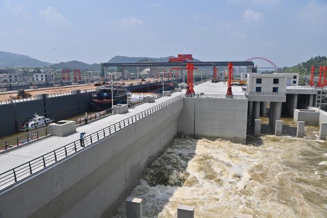 (260812) -- LINGSHAN, Aug. 12, 2026 (Xinhua) -- This photo taken on Aug. 12, 2026 shows a navigation lock sluicing to lower the water level on the Pinglu Canal in south China's Guangxi Zhuang Autonomous Region. Pinglu Canal started vessel trials on Wednesday, marking a key step toward the planned opening of this major Chinese waterway in September.
   The tests will assess navigation under both normal and adverse conditions and examine whether the canal's waterways, locks, anchorages, service areas and navigation facilities are ready for operation.
   Designed to accommodate vessels of up to 5,000 tonnes, the 134.2-km Pinglu Canal is China's first major river-to-sea canal project planned and coordinated at the national level since 1949.
   Stretching from the Pingtang River in Guangxi's Hengzhou City to the Beibu Gulf in the South China Sea, the canal is the backbone of the country's New International Land-Sea Trade Corridor, which has evolved into a strategic route linking China's inland regions with ASEAN and other global markets. (Xinhua/Zhou Hua)