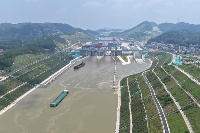 (260812) -- LINGSHAN, Aug. 12, 2026 (Xinhua) -- An aerial drone photo taken on Aug. 12, 2026 shows trial vessels driving past a navigation lock on the Pinglu Canal in south China's Guangxi Zhuang Autonomous Region. Pinglu Canal started vessel trials on Wednesday, marking a key step toward the planned opening of this major Chinese waterway in September.
   The tests will assess navigation under both normal and adverse conditions and examine whether the canal's waterways, locks, anchorages, service areas and navigation facilities are ready for operation.
   Designed to accommodate vessels of up to 5,000 tonnes, the 134.2-km Pinglu Canal is China's first major river-to-sea canal project planned and coordinated at the national level since 1949.
   Stretching from the Pingtang River in Guangxi's Hengzhou City to the Beibu Gulf in the South China Sea, the canal is the backbone of the country's New International Land-Sea Trade Corridor, which has evolved into a strategic route linking China's inland regions with ASEAN and other global markets. (Xinhua/Zhou Hua)