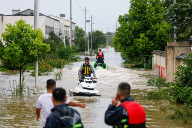 (260812) -- XIANGYANG, Aug. 12, 2026 (Xinhua) -- Rescue workers conduct operations using motorized boats in Nanwang Village of Xiangzhou District, Xiangyang City of central China's Hubei Province, Aug. 12, 2026. Torrential rains and flooding caused by Typhoon Dolphin, the 13th typhoon of the year, have swept vast regions in eastern and central China. Local authorities are exerting all efforts to eradicate potential risks and put people's life back to normal. (Xinhua/Wu Zhizun)